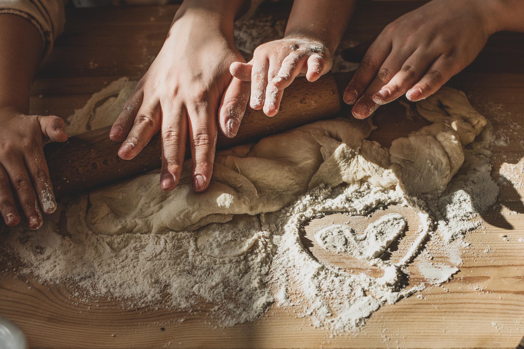 Hands kneading dough in workshop